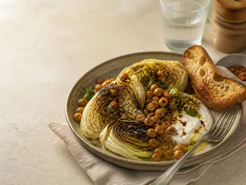 Five cabbage dinner components arranged around a roasted wedge