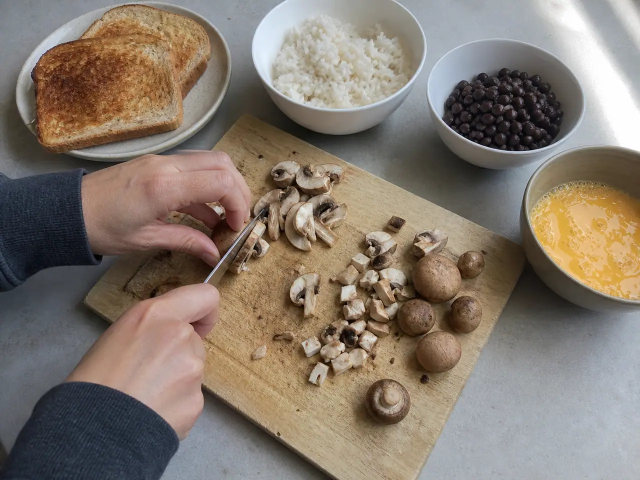 Hands cutting mushrooms into different shapes for five dinners