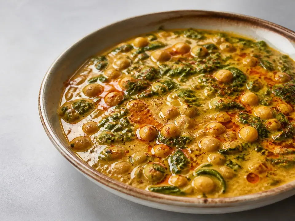 Coconut chickpea curry with greens and red chilli oil