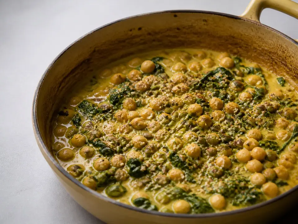 Coconut chickpea curry with greens and toasted pumpkin seeds