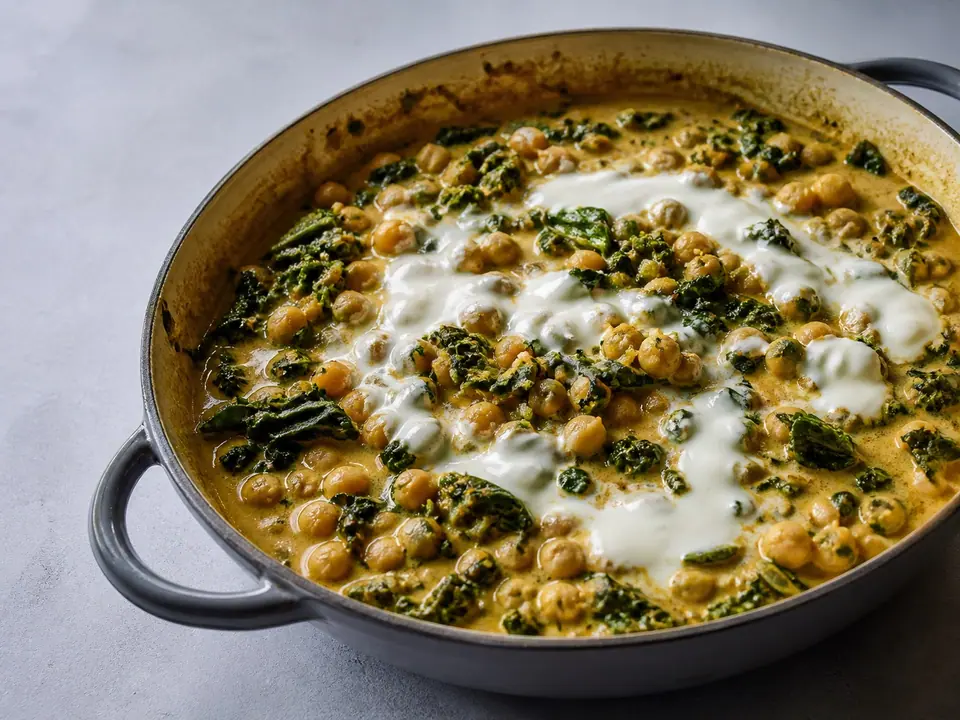 Coconut chickpea curry with greens and lemon yogurt