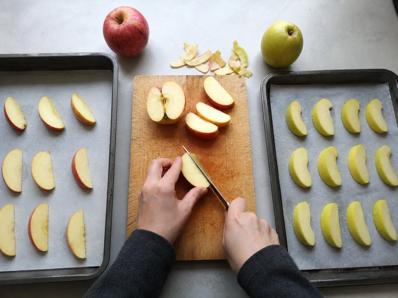 Hands slicing eating and cooking apples for an oven test