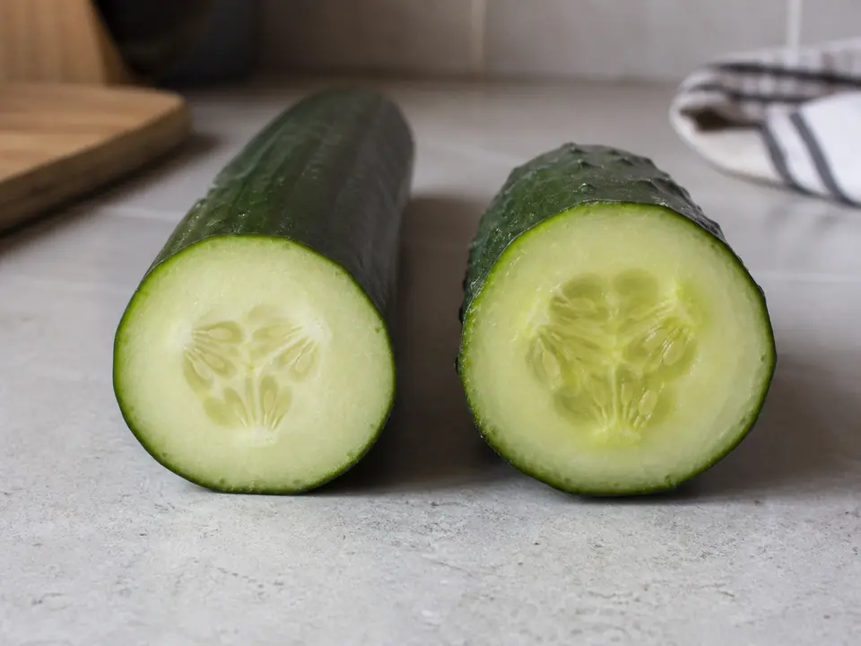 English cucumber and salad cucumber cut open for comparison