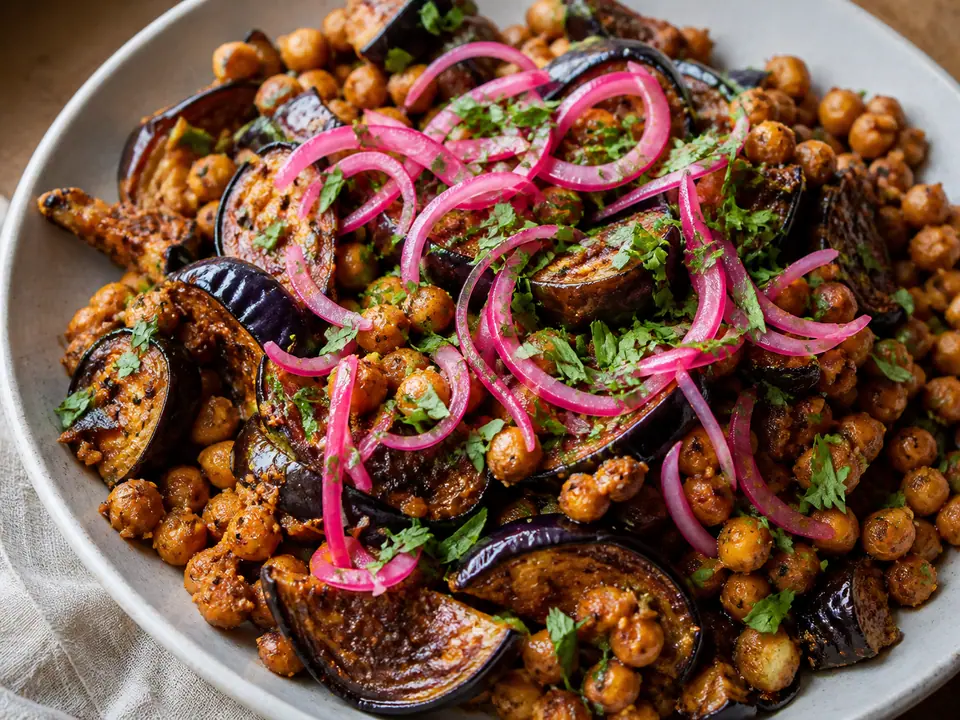 Harissa aubergine with chickpeas with pickled onions served in a roasting tin