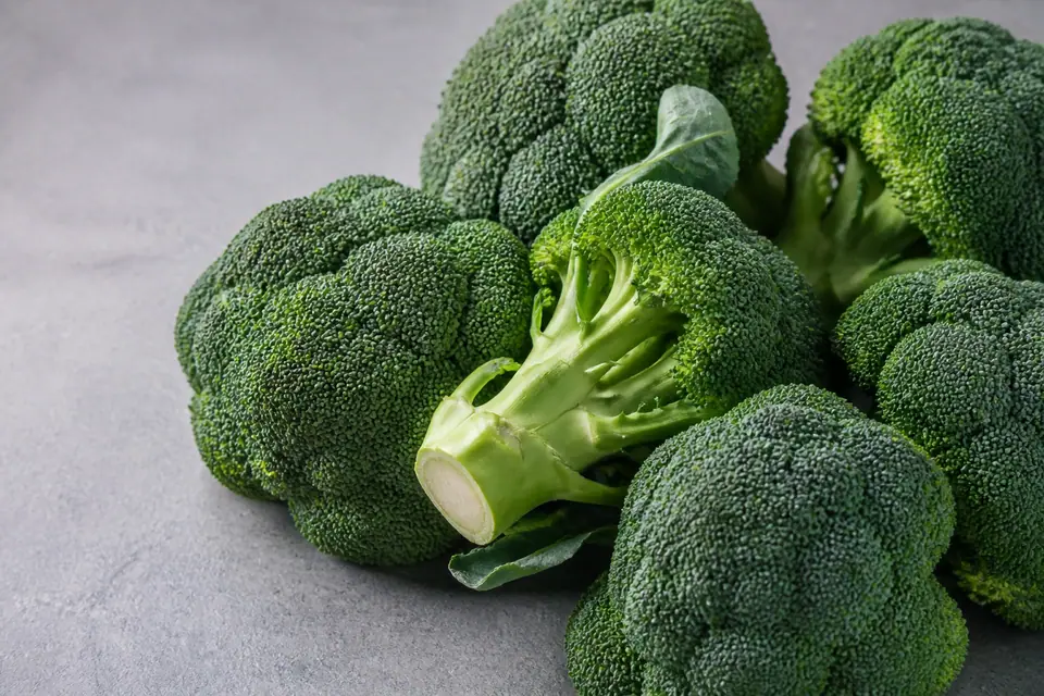 Fresh broccoli heads with tight green florets at a market