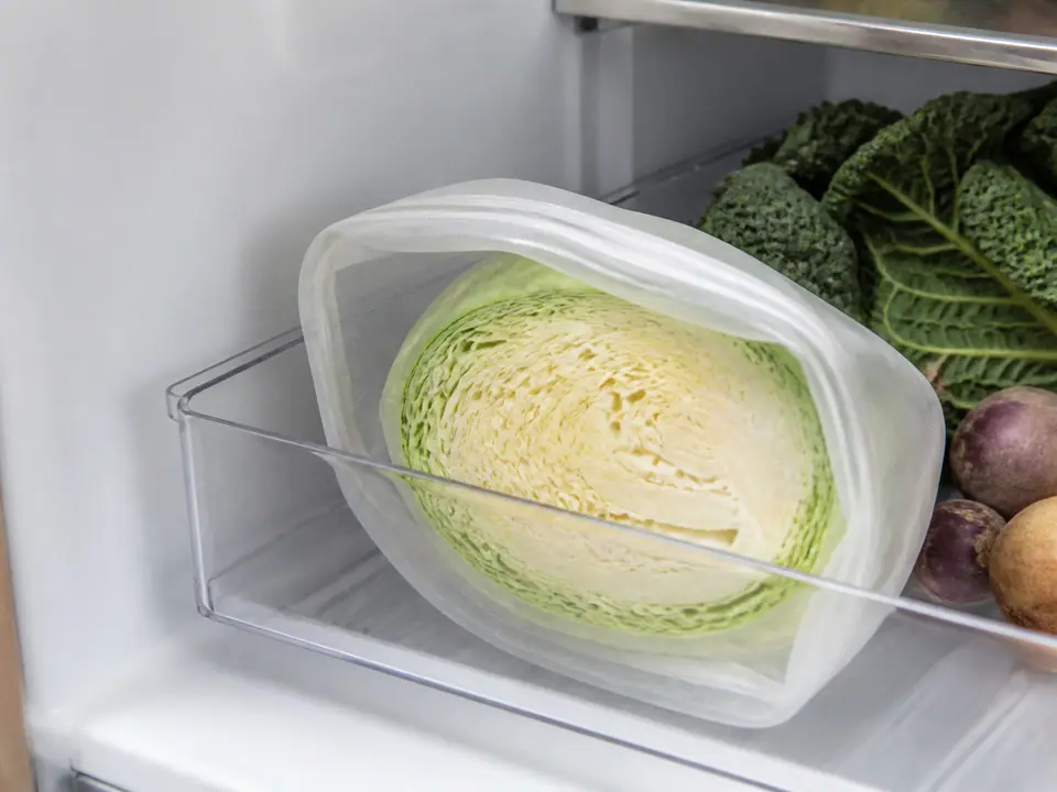 Half cabbage wrapped for storage in a refrigerator drawer