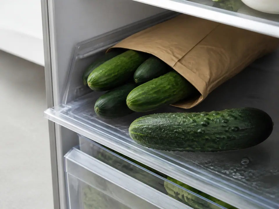 Cucumbers stored loosely in a protected refrigerator shelf