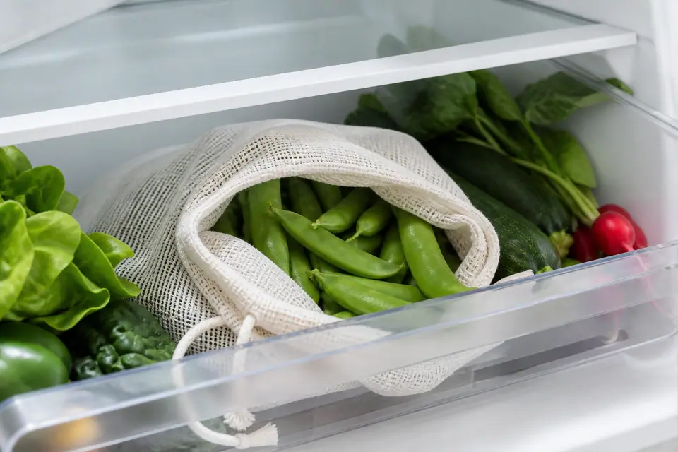 Fresh pea pods stored in a breathable bag in the refrigerator