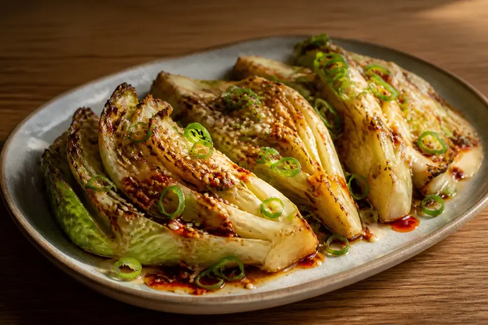 Roasted cabbage wedges with miso glaze red chilli oil and scallions