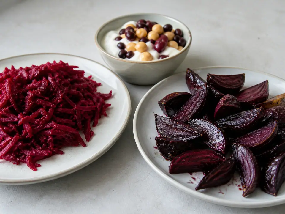 Raw and cooked beetroot beside a warm dinner plate