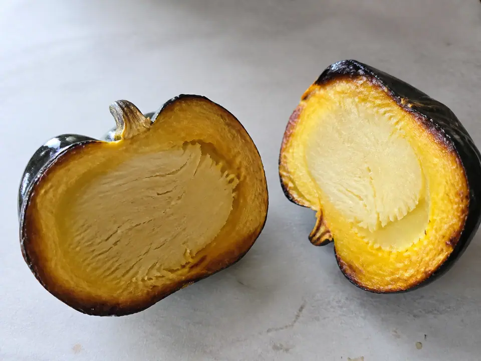 Roasted squash with browned edges and a hard centre cut open